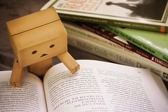 Image of a toy reading a book